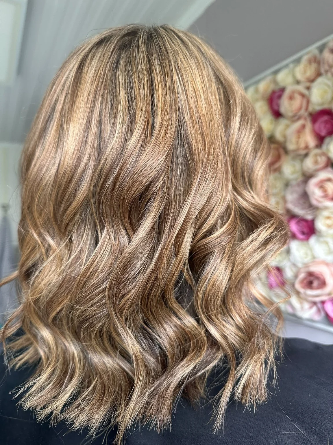 Shoulder-length brunette hair with honey highlights and soft waves